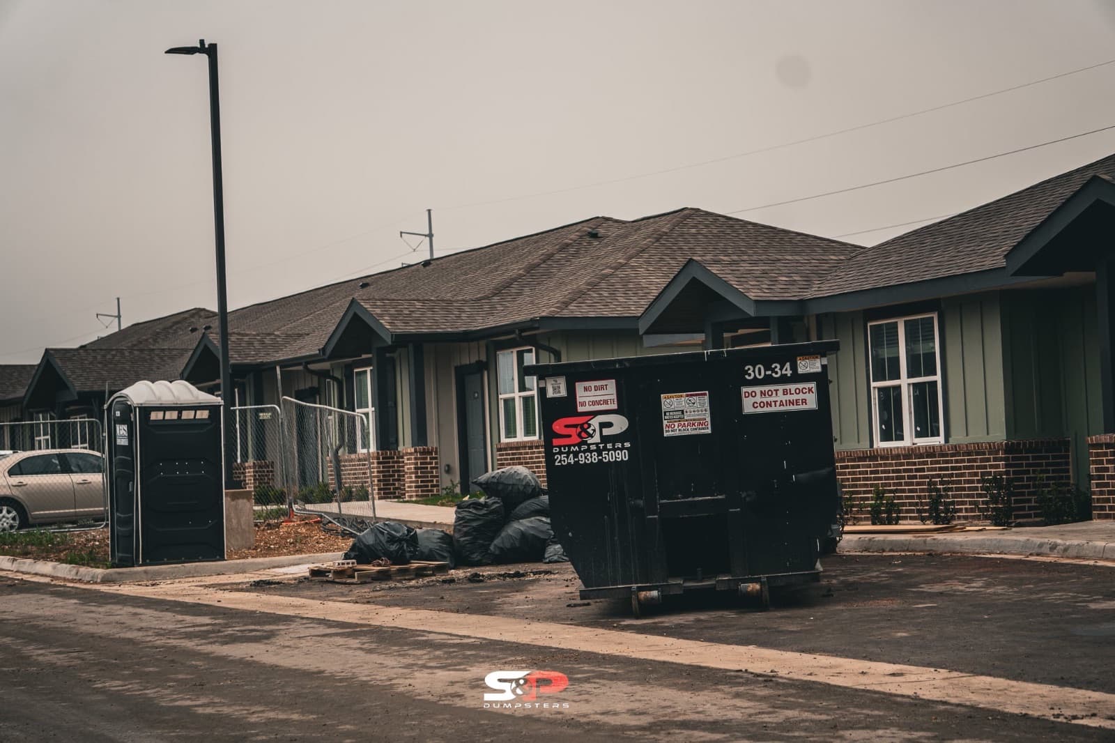 A 30-yard S&P container placed beside a new home